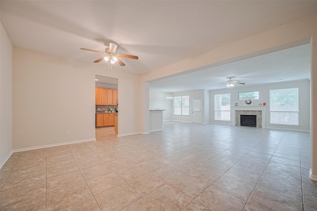 2938 Intrepid Elm St, Houston, TX 77084 - unfurnished living room with ceiling fan, light tile patterned floors, baseboards, and a fireplace