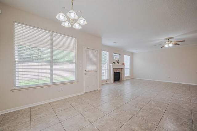 2938 Intrepid Elm St, Houston, TX 77084 - unfurnished living room featuring light tile patterned floors, healthy amount of natural light, a chandelier, baseboards, and a textured ceiling