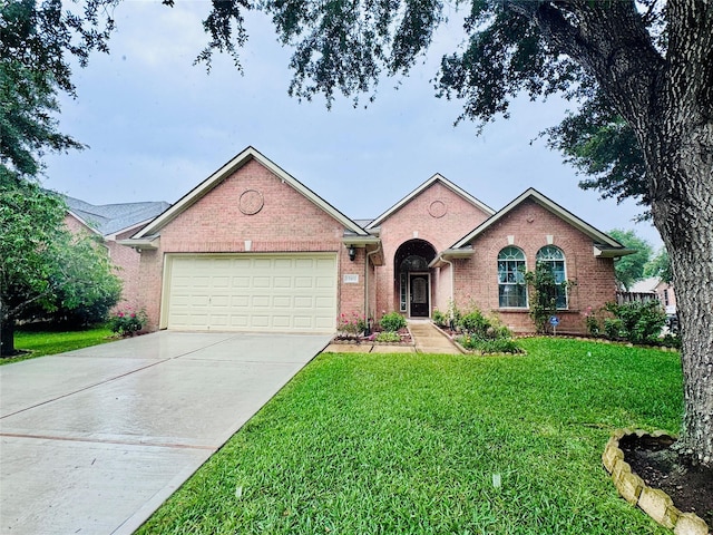 15102 Millers Run Ln, Sugar Land, TX 77498 - single story home with brick siding, a front lawn, a garage, and driveway