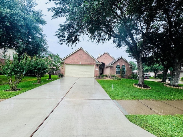 15102 Millers Run Ln, Sugar Land, TX 77498 - ranch-style house with concrete driveway, a front yard, a garage, and brick siding