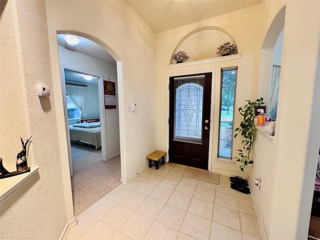 15102 Millers Run Ln, Sugar Land, TX 77498 - foyer featuring light tile patterned floors, arched walkways, and baseboards