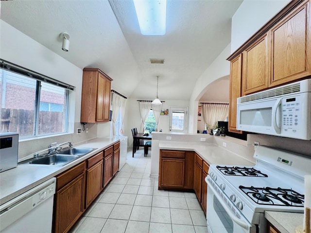 15102 Millers Run Ln, Sugar Land, TX 77498 - kitchen with white appliances, a sink, light countertops, lofted ceiling, and light tile patterned floors