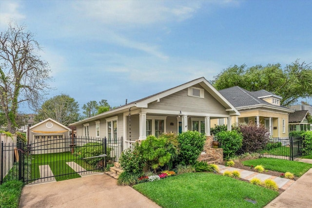 2621 Morrison St, Houston, TX 77009 - view of front of house featuring a gate, a porch, a detached garage, and driveway