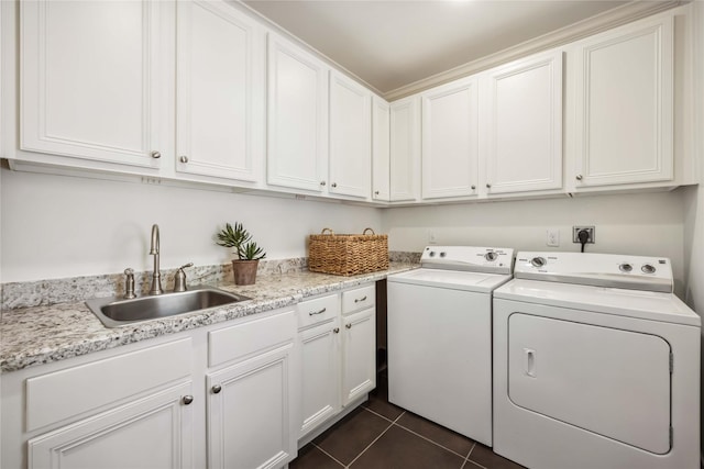 2621 Morrison St, Houston, TX 77009 - washroom with washer and clothes dryer, cabinet space, and dark tile patterned floors