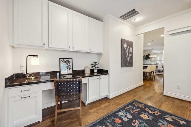 2621 Morrison St, Houston, TX 77009 - bar featuring dark wood-type flooring, ornamental molding, and baseboards