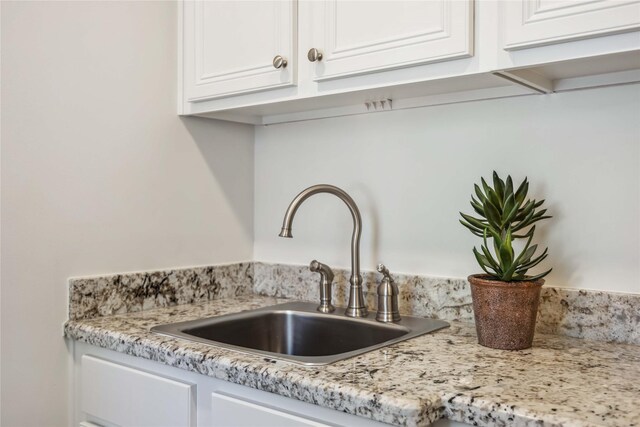 2621 Morrison St, Houston, TX 77009 - detailed view of a sink, white cabinetry, and light stone counters