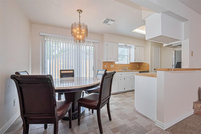 13207 Robinglen Dr, Houston, TX 77083 - dining room with a chandelier and baseboards