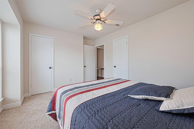 13207 Robinglen Dr, Houston, TX 77083 - carpeted bedroom with baseboards and a ceiling fan