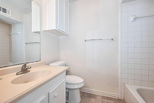 13207 Robinglen Dr, Houston, TX 77083 - bathroom featuring vanity, toilet, baseboards, and shower / bathtub combination