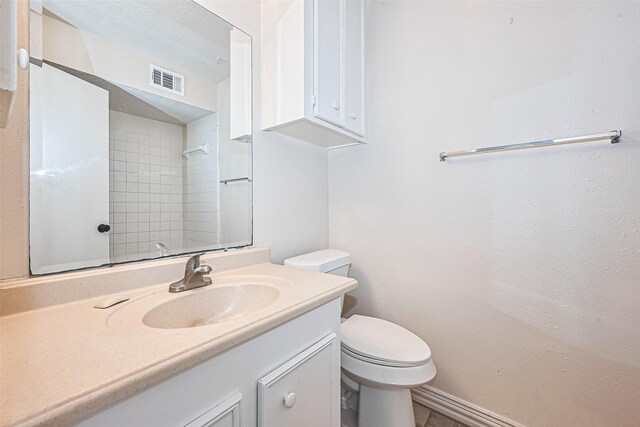 13207 Robinglen Dr, Houston, TX 77083 - bathroom with toilet, vanity, and a shower