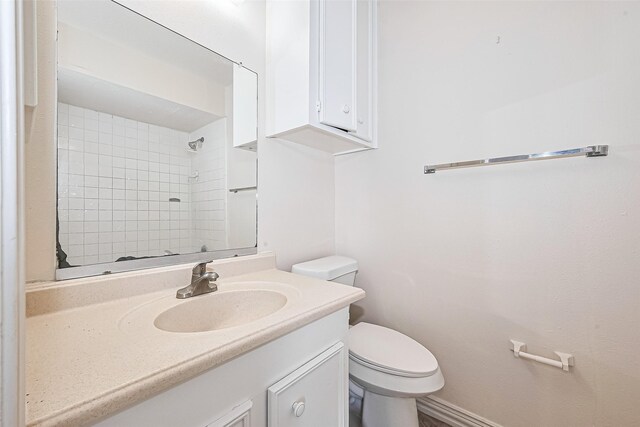 13207 Robinglen Dr, Houston, TX 77083 - full bathroom featuring toilet, vanity, and a tile shower