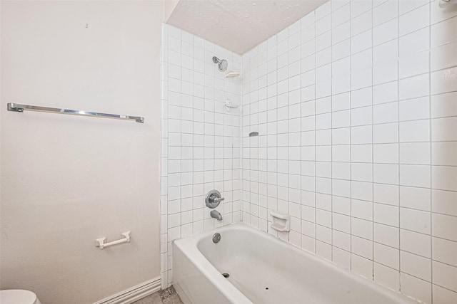 13207 Robinglen Dr, Houston, TX 77083 - bathroom featuring bathing tub / shower combination, baseboards, and toilet