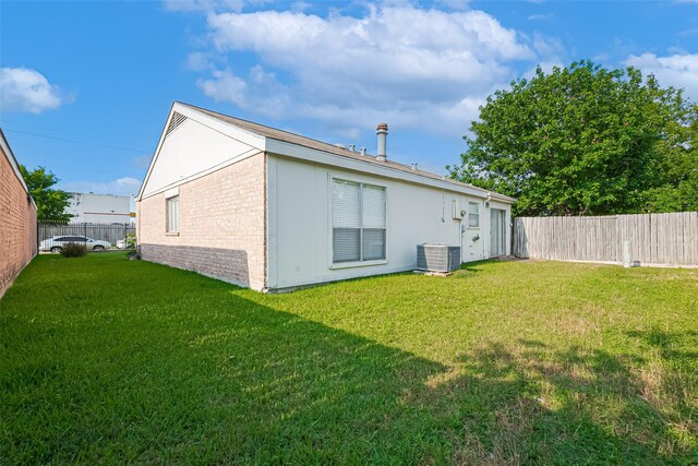 13207 Robinglen Dr, Houston, TX 77083 - rear view of house featuring brick siding and central air condition unit