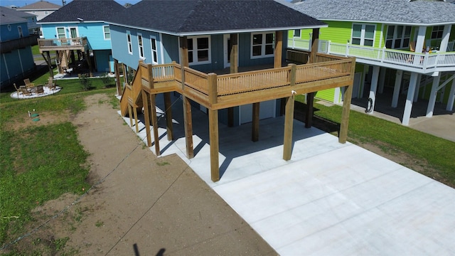 969 Bahama Rd, Crystal Beach, TX 77650 - rear view of house with roof with shingles, concrete driveway, a yard, and a carport