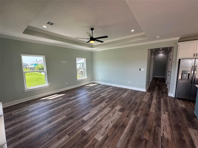 969 Bahama Rd, Crystal Beach, TX 77650 - unfurnished living room featuring a raised ceiling, dark wood-style flooring, ceiling fan, baseboards, and crown molding