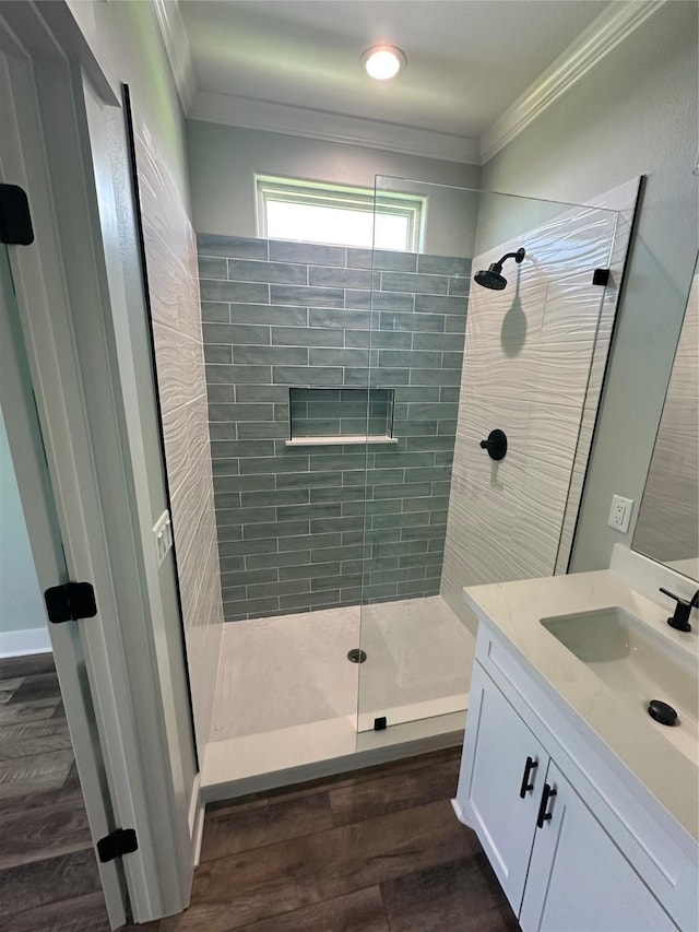 969 Bahama Rd, Crystal Beach, TX 77650 - full bathroom featuring tiled shower, vanity, wood finished floors, and ornamental molding