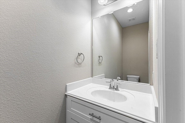 6510 Arabella, Houston, TX 77091 - bathroom with a textured wall, vanity, and toilet