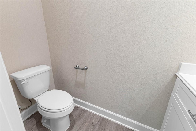 6510 Arabella, Houston, TX 77091 - bathroom with wood finished floors, toilet, baseboards, vanity, and a textured wall