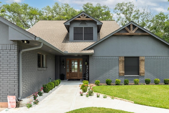 307 County Road 416, Brazoria, TX 77422 - view of front of house featuring brick siding, roof with shingles, and a front lawn