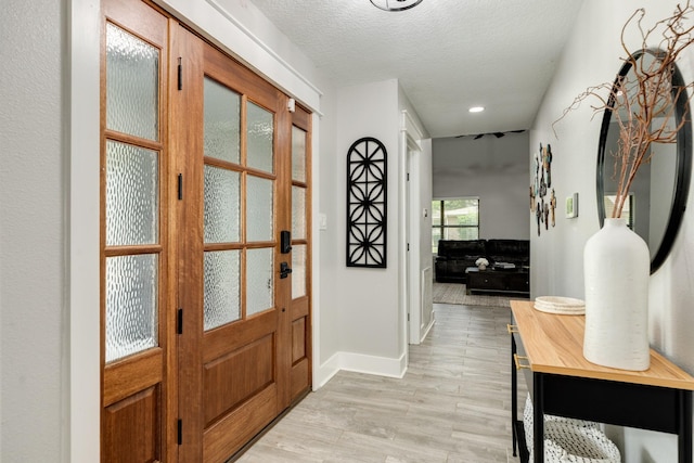 307 County Road 416, Brazoria, TX 77422 - entrance foyer featuring light wood-style floors, a textured ceiling, baseboards, and recessed lighting