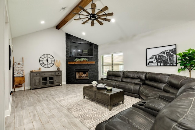 307 County Road 416, Brazoria, TX 77422 - living area with light wood-style flooring, ceiling fan, a stone fireplace, and baseboards