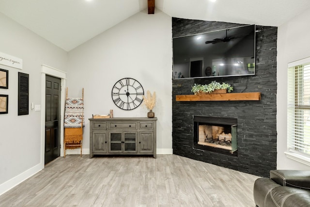 307 County Road 416, Brazoria, TX 77422 - living room featuring wood finished floors, a stone fireplace, and baseboards