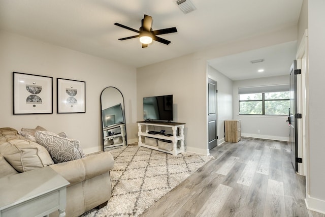 307 County Road 416, Brazoria, TX 77422 - living room with ceiling fan, light wood-style flooring, and baseboards