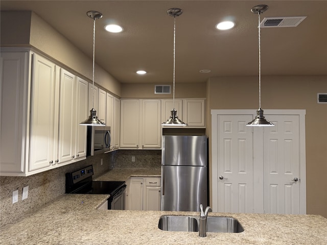 87 April Point Dr S, Conroe, TX 77356 - kitchen featuring appliances with stainless steel finishes, decorative backsplash, a sink, light stone countertops, and hanging light fixtures
