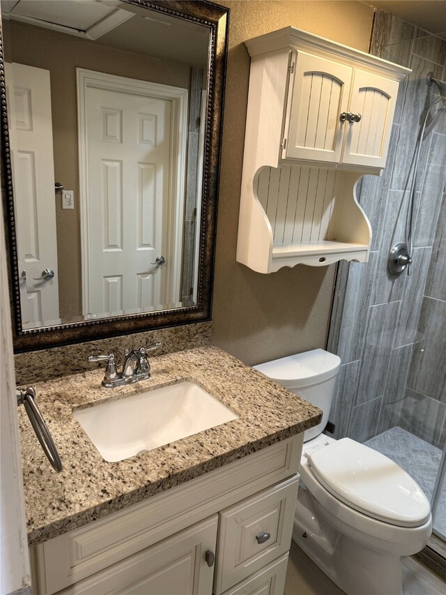 87 April Point Dr S, Conroe, TX 77356 - bathroom with vanity, tiled shower, and toilet