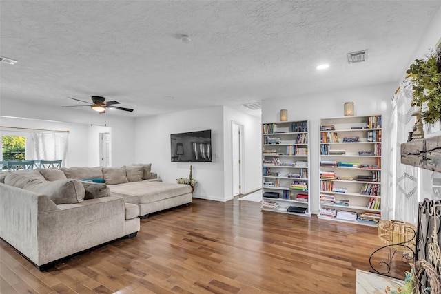 1710 Hill Top Ln, Houston, TX 77339 - living room with wood finished floors, a textured ceiling, ceiling fan, and baseboards