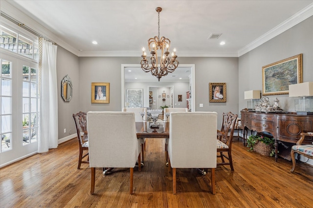 1216 Potomac Dr, Houston, TX 77057 - dining area with wood finished floors, a chandelier, recessed lighting, ornamental molding, and baseboards