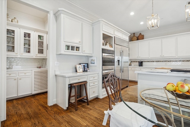 1216 Potomac Dr, Houston, TX 77057 - kitchen with appliances with stainless steel finishes, decorative backsplash, light countertops, white cabinets, and recessed lighting