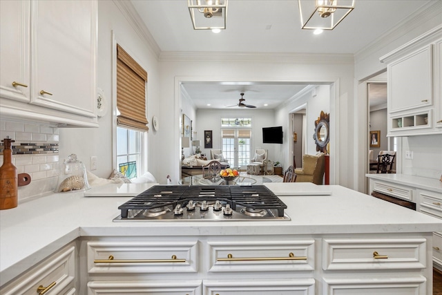 1216 Potomac Dr, Houston, TX 77057 - kitchen featuring decorative backsplash, ceiling fan, white cabinetry, light countertops, and stainless steel gas stovetop