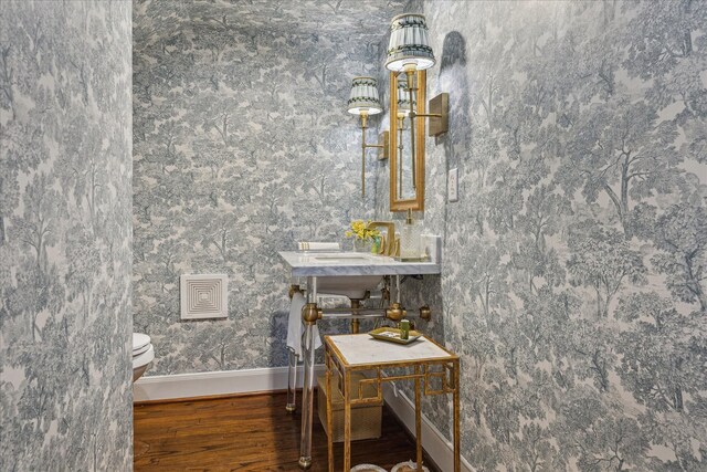 1216 Potomac Dr, Houston, TX 77057 - half bathroom featuring wood finished floors, baseboards, and toilet