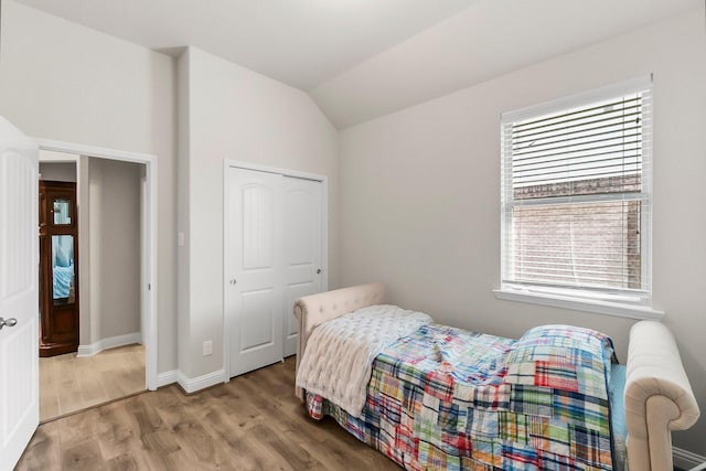 8202 Lockridge Terrace Ln, Cypress, TX 77433 - bedroom featuring wood finished floors, baseboards, lofted ceiling, and a closet