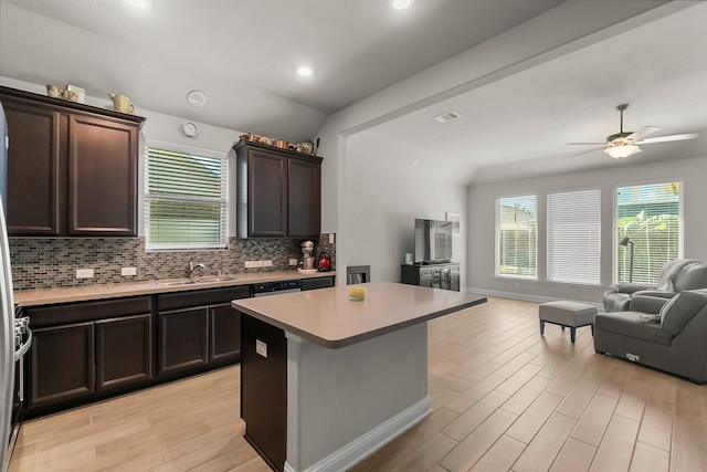 8202 Lockridge Terrace Ln, Cypress, TX 77433 - kitchen featuring open floor plan, light wood-style floors, tasteful backsplash, light countertops, and ceiling fan
