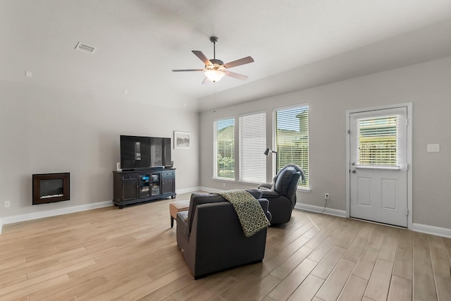 8202 Lockridge Terrace Ln, Cypress, TX 77433 - living room featuring light wood-style floors, ceiling fan, baseboards, and vaulted ceiling