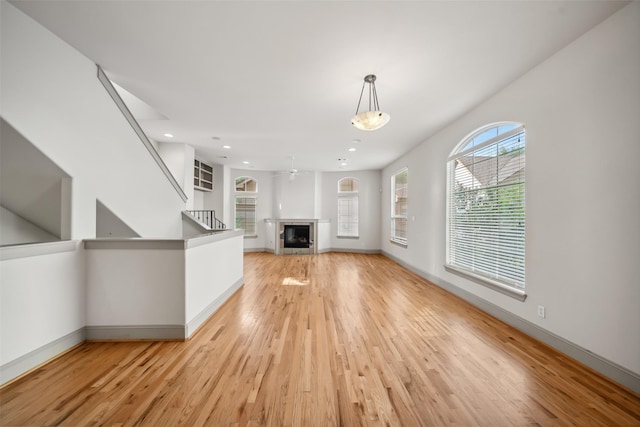 5012 Schuler St, Houston, TX 77007 - unfurnished living room with light wood-style flooring, baseboards, a fireplace, recessed lighting, and a ceiling fan