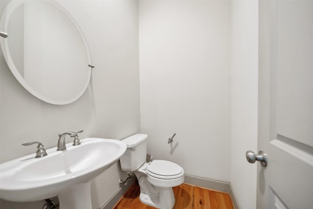 5012 Schuler St, Houston, TX 77007 - half bath featuring wood finished floors, toilet, and a sink