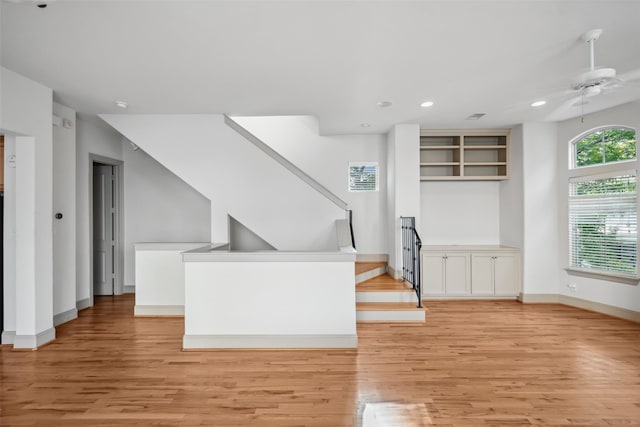 5012 Schuler St, Houston, TX 77007 - unfurnished living room featuring light wood finished floors, ceiling fan, stairs, baseboards, and recessed lighting