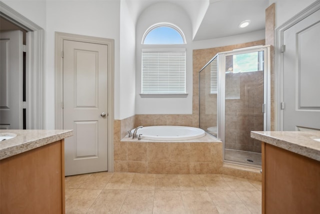 5012 Schuler St, Houston, TX 77007 - bathroom featuring vanity, a garden tub, a shower stall, tile patterned flooring, and healthy amount of natural light