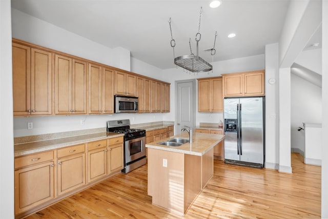 5012 Schuler St, Houston, TX 77007 - kitchen with appliances with stainless steel finishes, a sink, a kitchen island with sink, light wood-type flooring, and recessed lighting