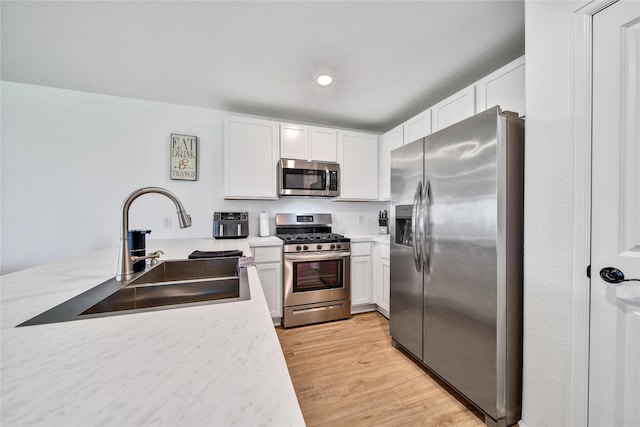 5003 Stratton Ln, Rosharon, TX 77583 - kitchen with appliances with stainless steel finishes, a sink, light countertops, white cabinetry, and recessed lighting