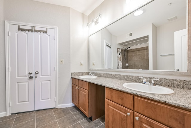 1711 Old Spanish Trl Unit 330, Houston, TX 77054 - full bathroom featuring double vanity, tile patterned floors, tiled shower, and baseboards