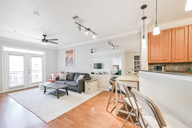 1711 Old Spanish Trl Unit 330, Houston, TX 77054 - living area with ceiling fan, crown molding, french doors, light wood finished floors, and track lighting