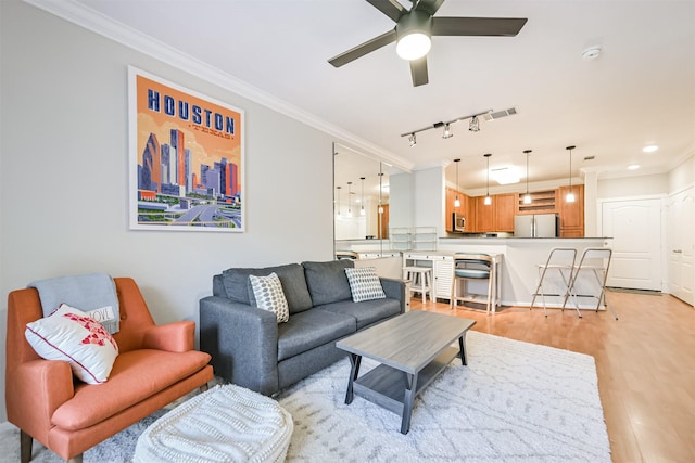1711 Old Spanish Trl Unit 330, Houston, TX 77054 - living area featuring crown molding, a ceiling fan, light wood finished floors, recessed lighting, and rail lighting