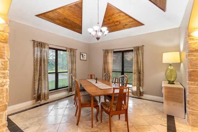 632 Western Acres Dr, El Campo, TX 77437 - dining area with a chandelier, inlaid floor details, baseboards, and a tray ceiling