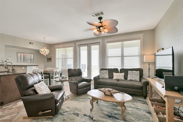 27020 Estuary Dr Unit 302, Galveston, TX 77554 - living room featuring a chandelier and a ceiling fan