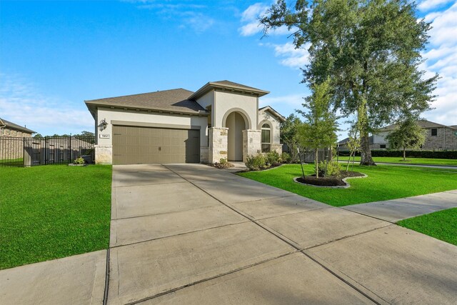 5160 Andorra Bend Ln, Porter, TX 77365 - mediterranean / spanish-style house with a garage, stucco siding, driveway, and stone siding