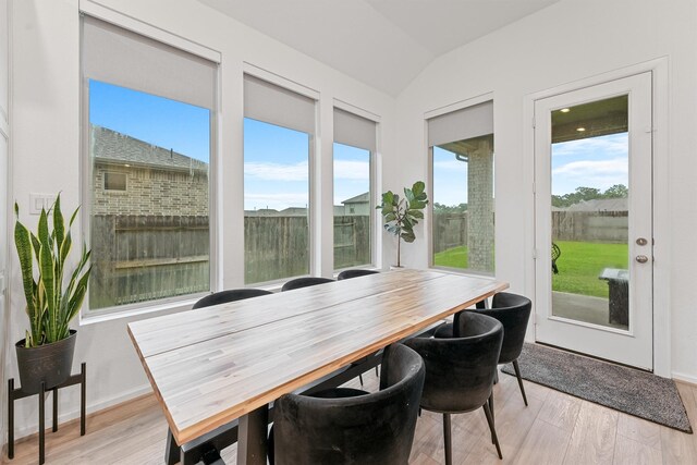 5160 Andorra Bend Ln, Porter, TX 77365 - dining space featuring light wood finished floors, vaulted ceiling, and baseboards